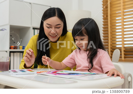 happy mother and preschool child girl painting on paper with watercolor in pan happy mother and preschool child girl painting on paper with watercolor in pan 138800789