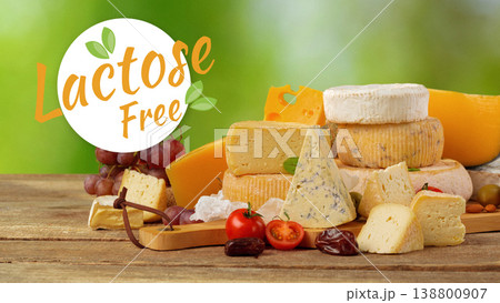 Selection of lactose and gluten free cheeses on a wooden table in a garden setting 138800907