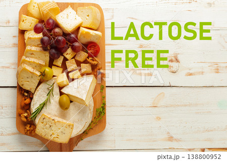 Lactose gluten free cheese platter with grapes and nuts on a wooden board 138800952