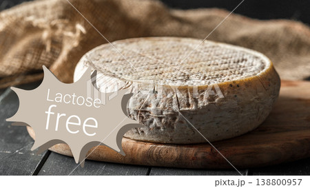 Lactose free cheese on wooden board with brown fabric in simple kitchen setting Lactose free cheese on wooden board with brown fabric in simple kitchen setting 138800957
