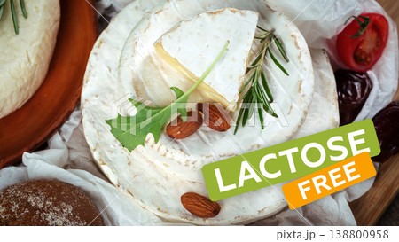 Lactose free cheese on a wooden table with nuts and herbs in a bright setting 138800958