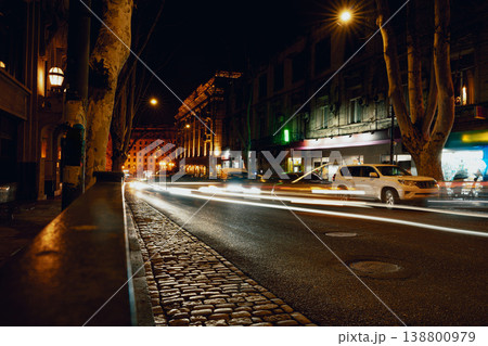 Night scene of traffic and buildings in a city street after dark Night scene of traffic and buildings in a city street after dark 138800979