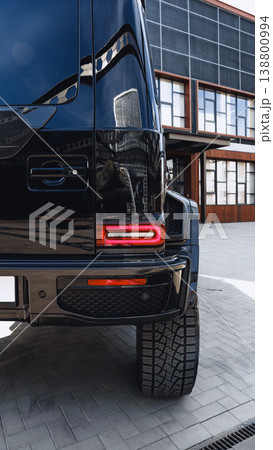 Luxury SUV parked in front of modern building during daytime in a city setting 138800994