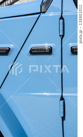 Bright blue vehicle door close up showing handle and hinges in a sunny area Bright blue vehicle door close up showing handle and hinges in a sunny area 138801012