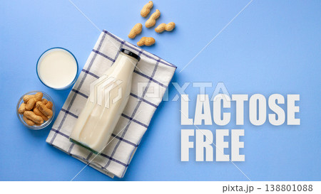 Lactose free milk and peanuts on a blue table with a checkered cloth Lactose free milk and peanuts on a blue table with a checkered cloth 138801088