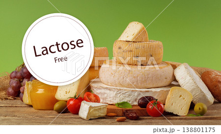 Lactose free cheese display with fresh ingredients and vegetables on a wooden table 138801175