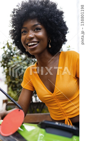 Young woman enjoys outdoor gardening in a sunny location during spring season Young woman enjoys outdoor gardening in a sunny location during spring season 138801198