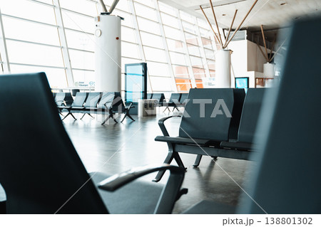Seats in an empty airport terminal during daytime waiting for passengers 138801302