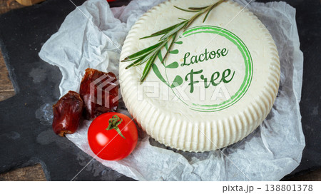 Lactose and gluten free cheese placed on a slate with vegetables and herbs Lactose and gluten free cheese placed on a slate with vegetables and herbs 138801378