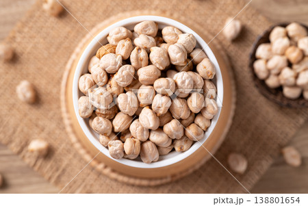 Organic raw chickpeas in a white bowl, healthy food ingredient, Table top view Organic raw chickpeas in a white bowl, healthy food ingredient, Table top view 138801654