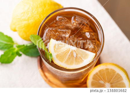 Refreshing iced lemon tea in a glass with sliced lemon and mint leaves 138801682