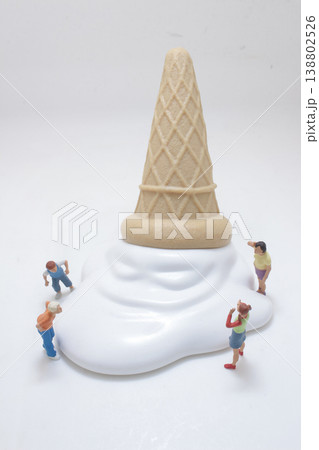 Miniature Figures Surrounding Giant Ice Cream 138802526