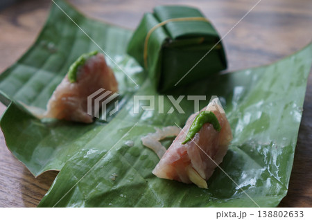 Authentic Thai Naem Moo or fermented pork sausage in selective focus. wrapped in banana leaf 138802633