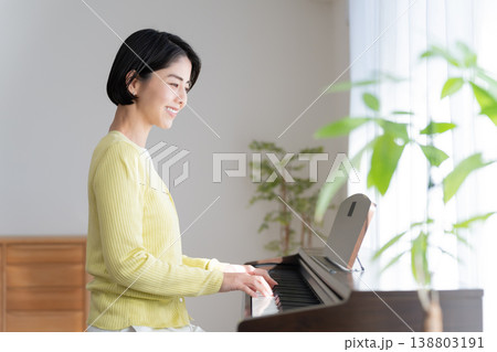 家で電子ピアノを弾く女性 138803191