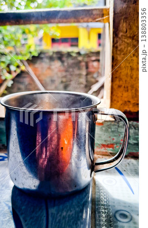close up image of a cup of hot coffee with smoke coming from the cup 138803356