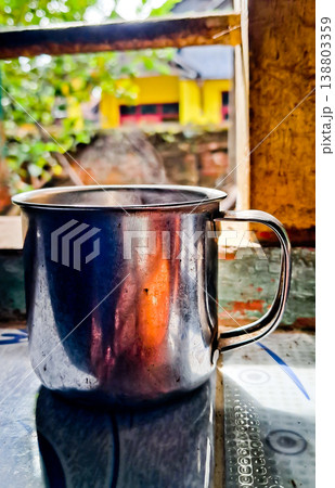 close up image of a cup of hot coffee with smoke coming from the cup 138803359