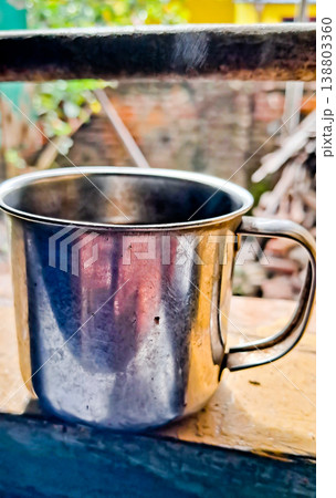 close up image of a cup of hot coffee with smoke coming from the cup 138803360