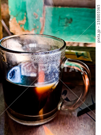 close up image of a cup of hot coffee with smoke coming from the cup close up image of a cup of hot coffee with smoke coming from the cup 138803365