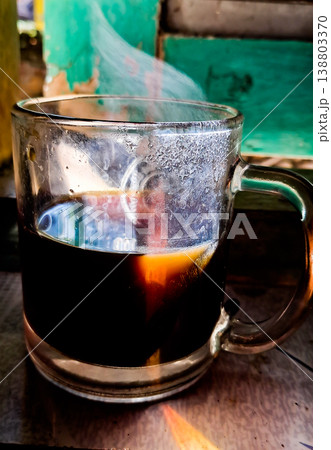 close up image of a cup of hot coffee with smoke coming from the cup 138803370