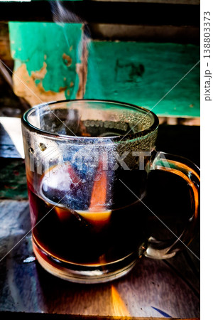 close up image of a cup of hot coffee with smoke coming from the cup 138803373