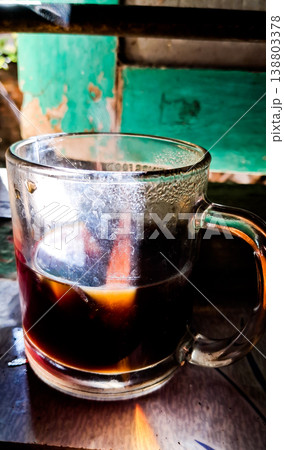 close up image of a cup of hot coffee with smoke coming from the cup 138803378