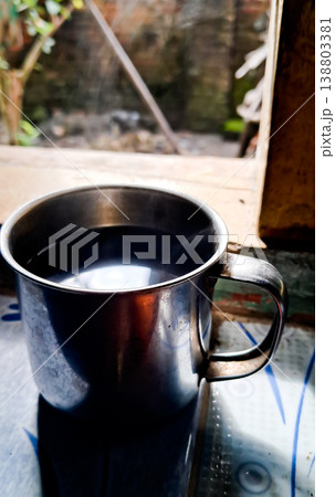 close up image of a cup of hot coffee with smoke coming from the cup 138803381