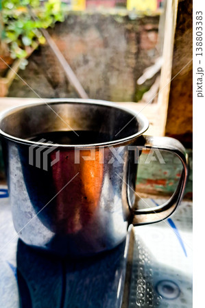 close up image of a cup of hot coffee with smoke coming from the cup 138803383