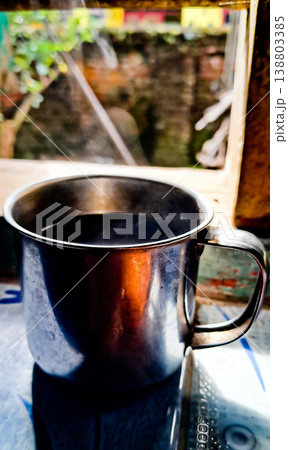 close up image of a cup of hot coffee with smoke coming from the cup 138803385