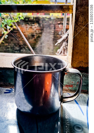 close up image of a cup of hot coffee with smoke coming from the cup close up image of a cup of hot coffee with smoke coming from the cup 138803386