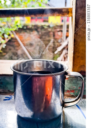 close up image of a cup of hot coffee with smoke coming from the cup close up image of a cup of hot coffee with smoke coming from the cup 138803387