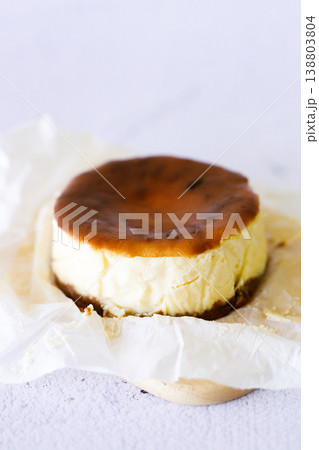 Cheesecake with baking paper on white marble table. Cheesecake with baking paper on white marble table. 138803804