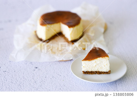 Cheesecake with baking paper on white marble table. 138803806