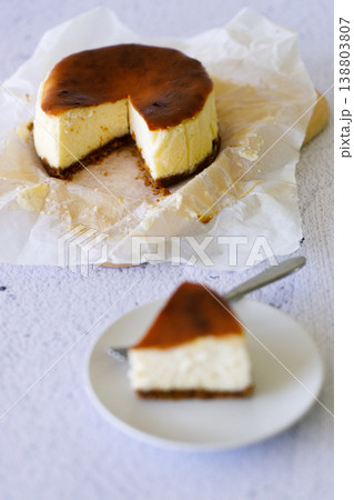Cheesecake with baking paper on white marble table. 138803807