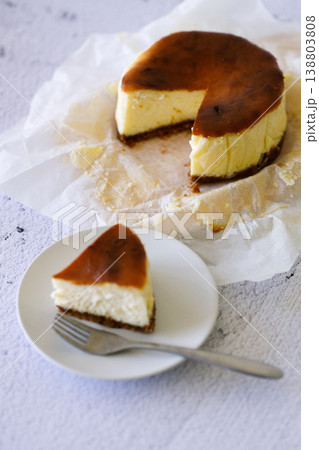Cheesecake with baking paper on white marble table. Cheesecake with baking paper on white marble table. 138803808