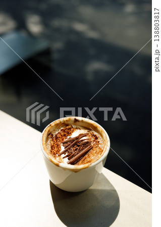 Cup of hot milk latte coffee on table by the window. Cup of hot milk latte coffee on table by the window. 138803817