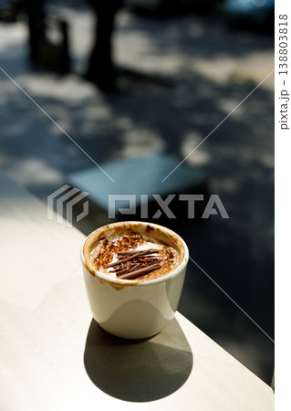 Cup of hot milk latte coffee on table by the window. 138803818