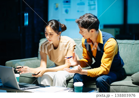 Asian couple working together with a tablet and laptop, discussing ideas with smiles. Concept of teamwork Asian couple working together with a tablet and laptop, discussing ideas with smiles. Concept of teamwork 138803976