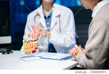 Asian female doctor consulting male patient in clinic. Healthcare, diagnosis, and medical advice concept with real people in hospital office setting. Asian female doctor consulting male patient in clinic. Healthcare, diagnosis, and medical advice concept with real people in hospital office setting. 138804055