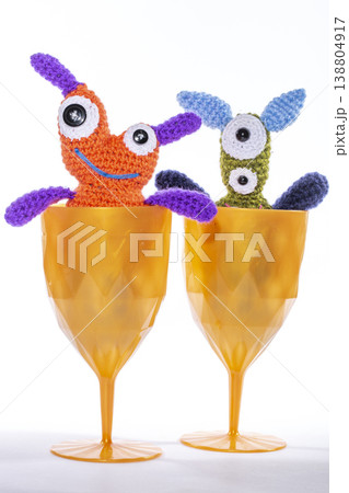 Knitted wool aliens in a glass on a white background 138804917