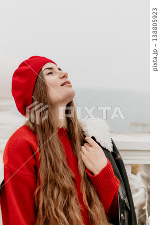 Woman beret balcony relaxing outdoors in a red sweater enjoying a peaceful moment overlooking the sea with copy space Woman beret balcony relaxing outdoors in a red sweater enjoying a peaceful moment overlooking the sea with copy space 138805923