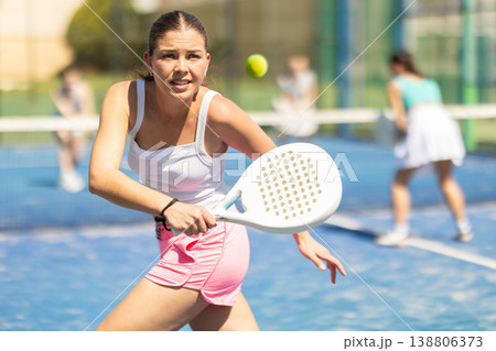 Woman on the court playing paddle tennis Woman on the court playing paddle tennis 138806373
