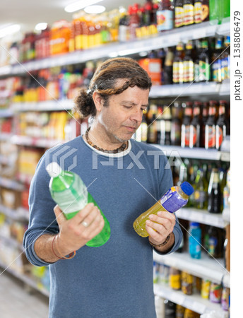 Man in supermarket choose drink 138806479