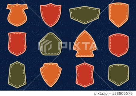 Shield embroidery patches on denim background vector collection with stitched badge shapes textile mockup for fashion apparel design isolated on dark fabric texture Shield embroidery patches on denim background vector collection with stitched badge shapes textile mockup for fashion apparel design isolated on dark fabric texture 138806579