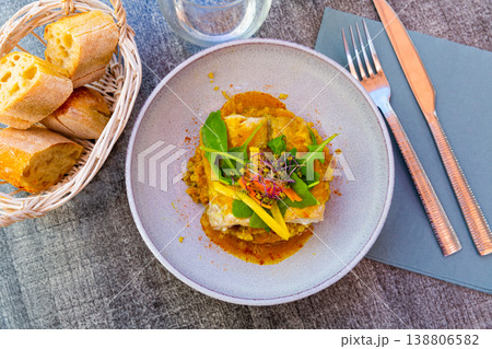 Fried pollock fillet with quinoa, curry and vegetables Fried pollock fillet with quinoa, curry and vegetables 138806582