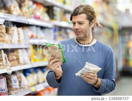 Man in supermarket choose groats 138806727