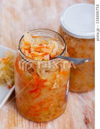 Glass jar with traditional Russian sauerkraut on table Glass jar with traditional Russian sauerkraut on table 138806758