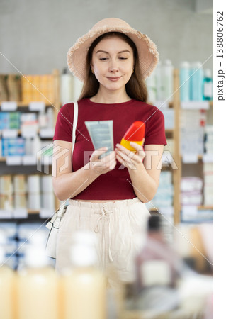Woman choosing sunscreen at pharmacy Woman choosing sunscreen at pharmacy 138806762