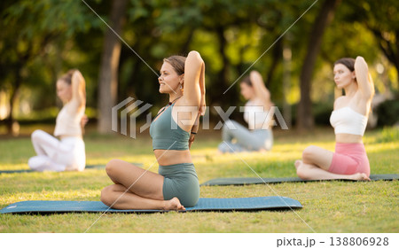 Group of young women doing yoga in cow head pose Group of young women doing yoga in cow head pose 138806928