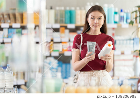 Young woman buyer select cream in drug store 138806988