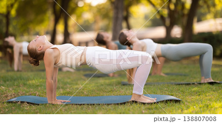 Group of young women doing yoga in park Group of young women doing yoga in park 138807008